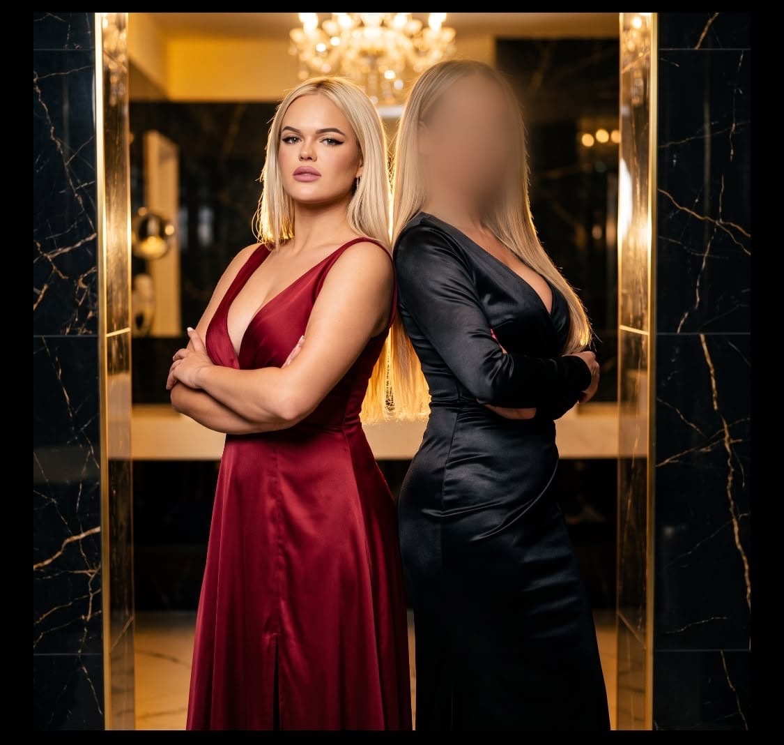 Stella und Jenny in eleganten Abendkleidern – rot und schwarz – in luxuriöser Hotel-Suite